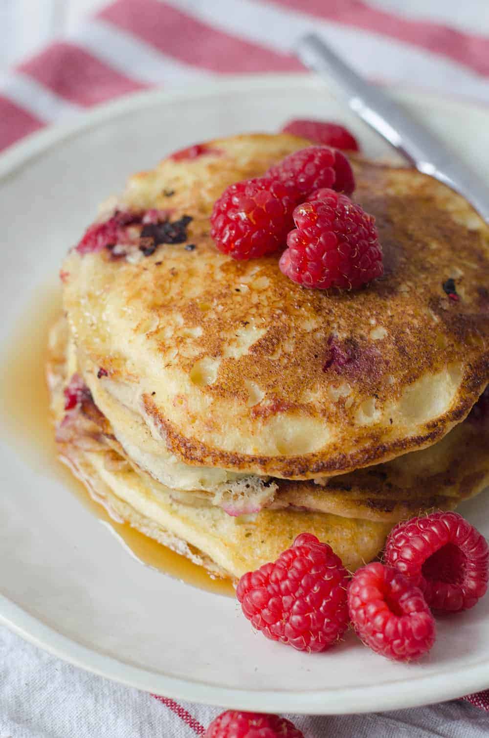 Lemon Raspberry Pancakes, Perfect For Valentines Day Brunch! Soft And Fluffy Pancakes Infused With Lemon Zest And Frozen Raspberries. | Www.delishknowledge.com