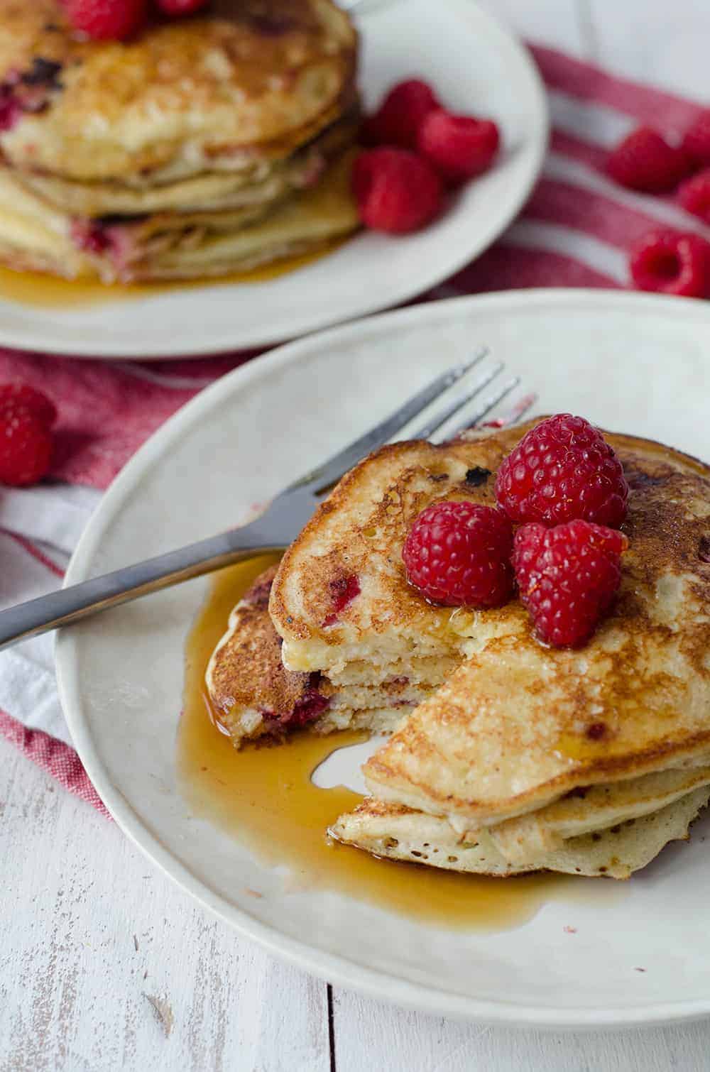 Lemon Raspberry Pancakes, Perfect For Valentines Day Brunch! Soft And Fluffy Pancakes Infused With Lemon Zest And Frozen Raspberries. | Www.delishknowledge.com