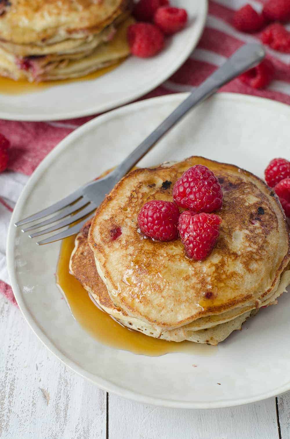 Lemon Raspberry Pancakes, Perfect For Valentines Day Brunch! Soft And Fluffy Pancakes Infused With Lemon Zest And Frozen Raspberries. | Www.delishknowledge.com