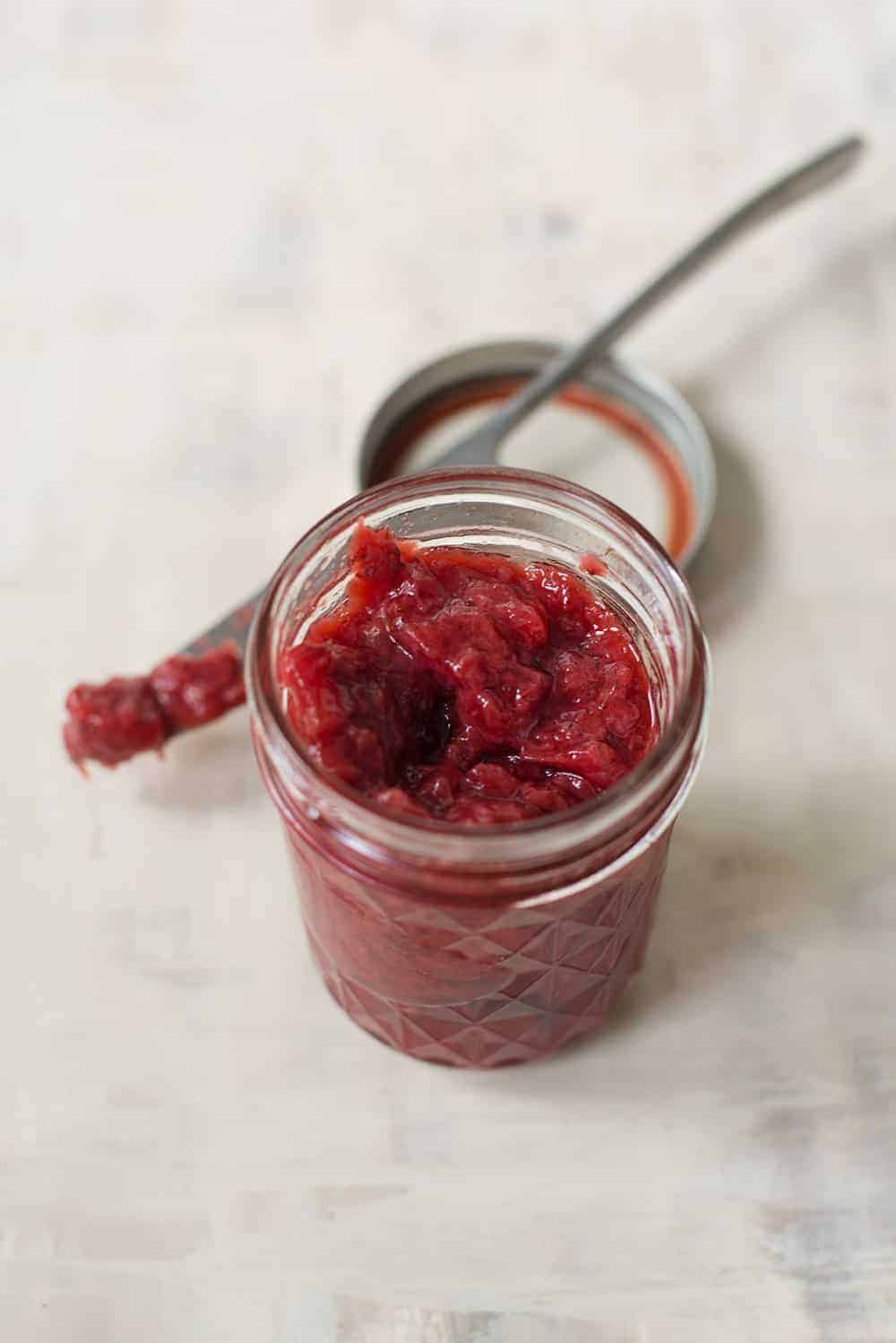 homemade strawberry jam in jar with knife