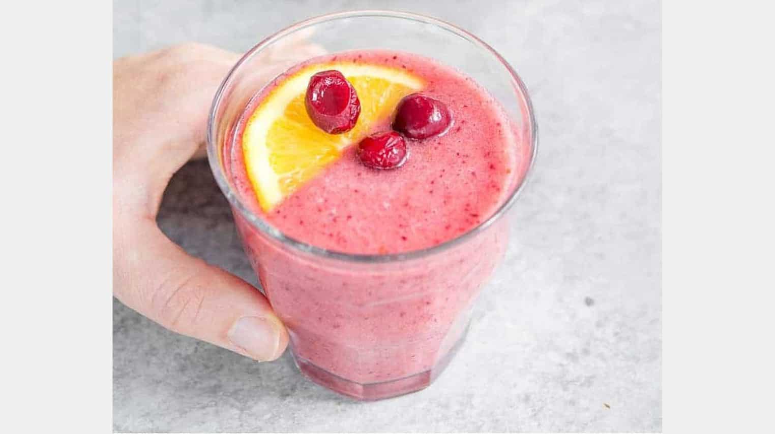 healing cranberry smoothie with hand for a vegan breakfast option