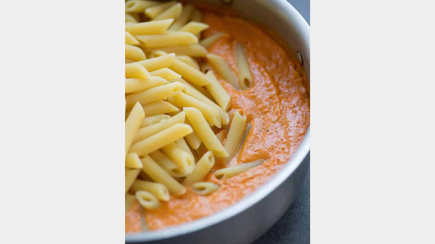 skillet with pasta and red pepper sauce