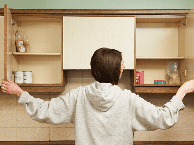 woman opening empty pantry