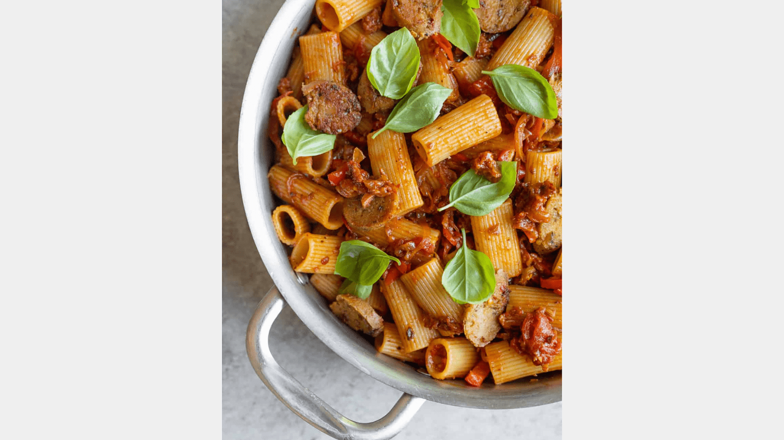 vegan pasta with sausage and peppers in a skillet