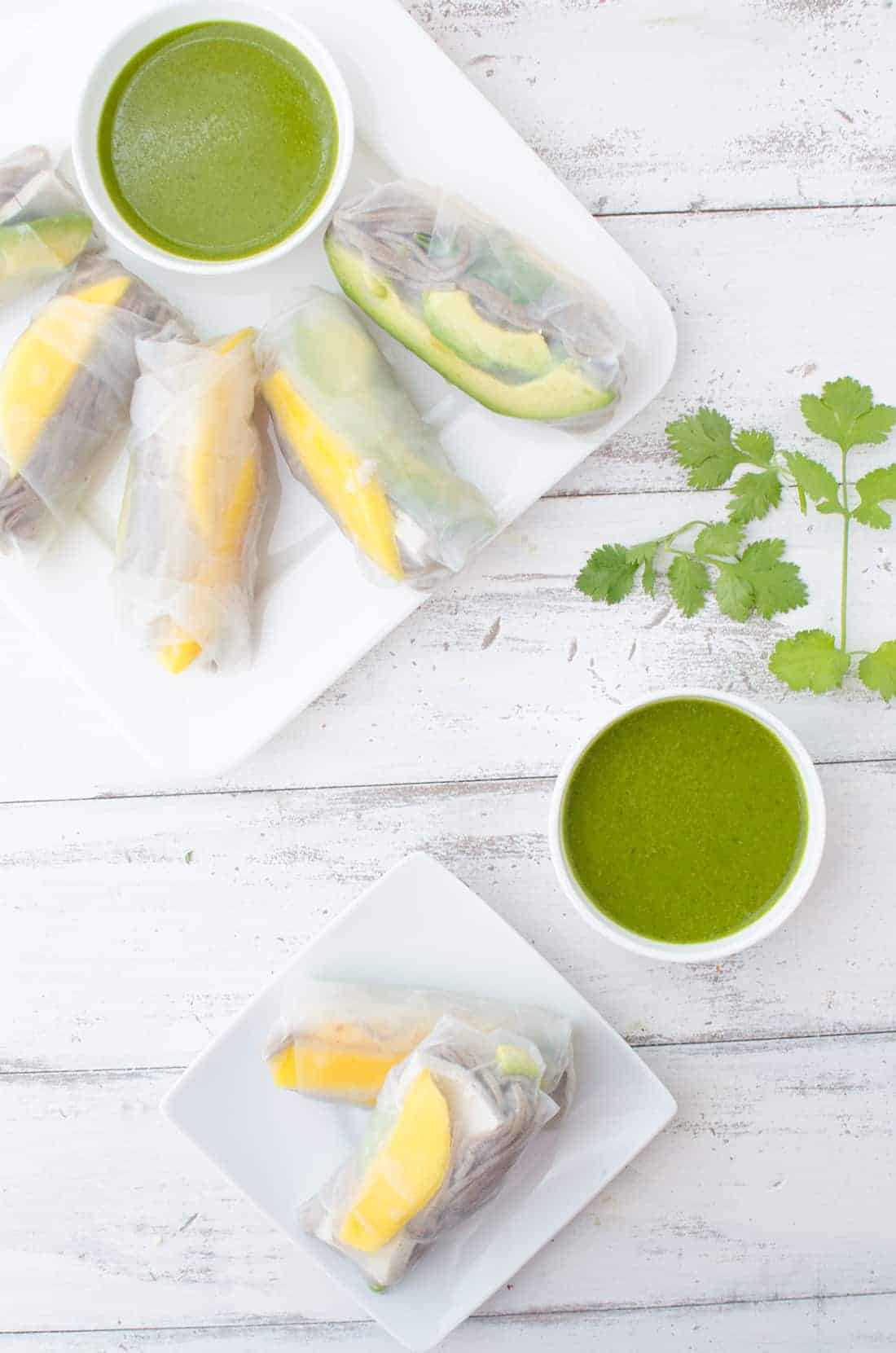 Top Down Image Of The Mango Spring Rolls With The Avocado Dipping Sauce