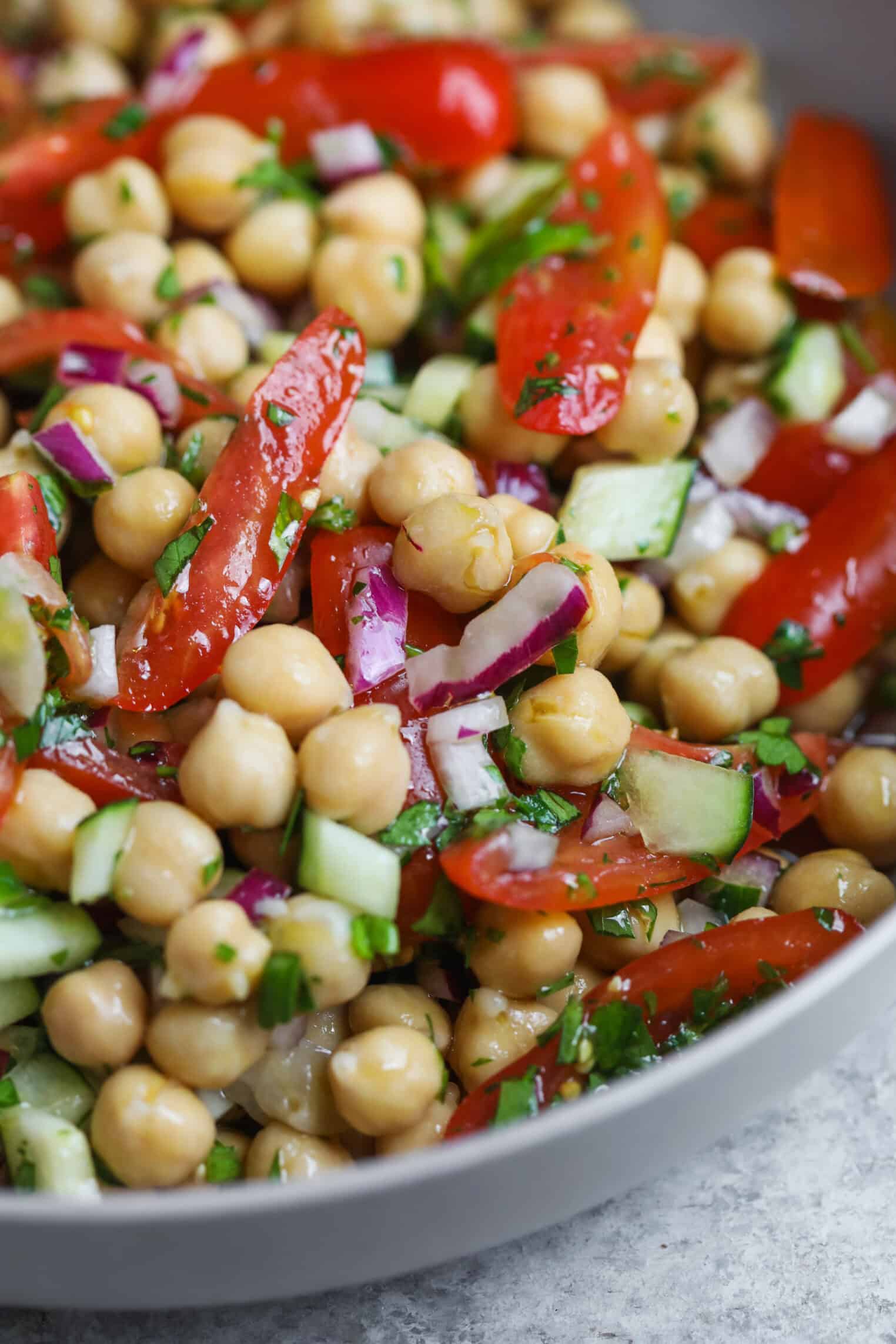 Marinated Chickpea Salad 1 Close-Up Of A Vibrant Chickpea Salad Featuring Chopped Tomatoes, Cucumbers, Red Onions, And Fresh Herbs, All Tossed Together In A Bowl For A Fresh, Healthy Bite.