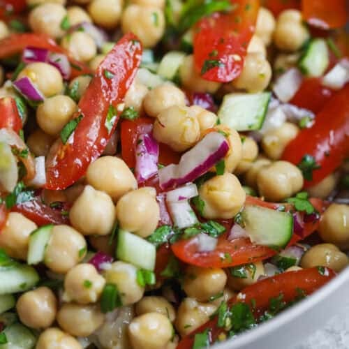 Marinated Chickpea Salad 8 Close-Up Of A Vibrant Chickpea Salad Featuring Chopped Tomatoes, Cucumbers, Red Onions, And Fresh Herbs, All Tossed Together In A Bowl For A Fresh, Healthy Bite.