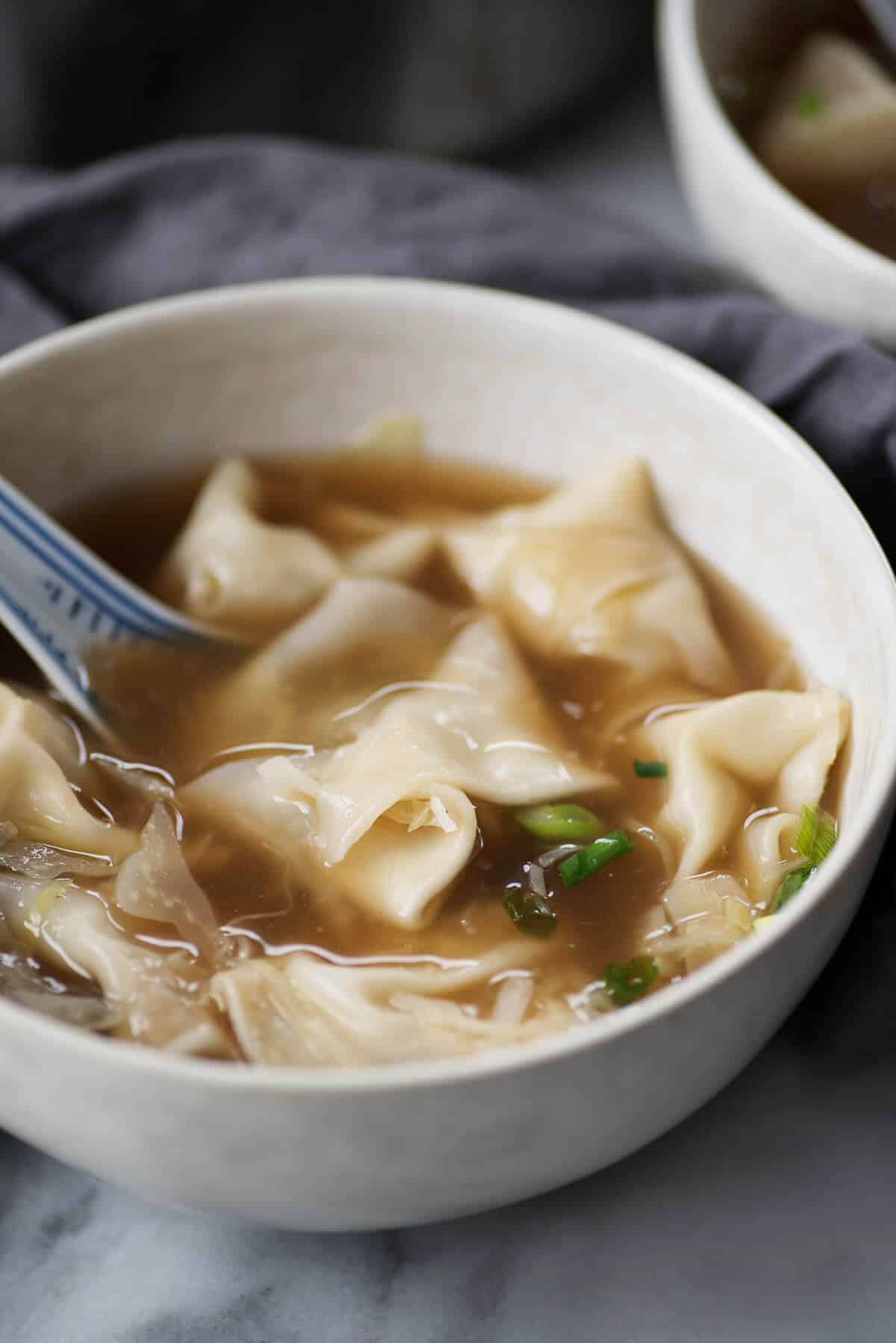 bowl of soup with mushroom wontons