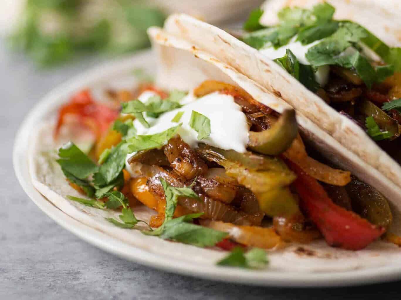 Oven Roasted Fajitas! These veggie fajitas are such a simple meal. Throw everything in the oven and dinner is ready in just 30 minutes. Customize them however you like 'em. | www.delishknowledge.com