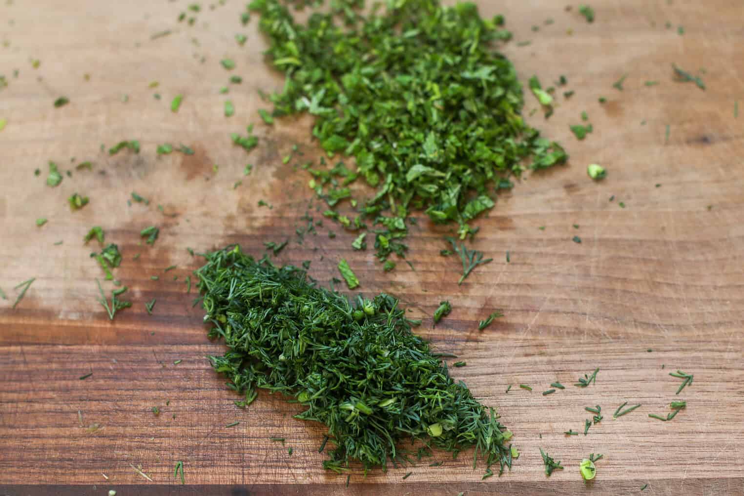 Spring Pea, Mint and Wheat Berry Salad 6 Finely Chopped Fresh Herbs, Including Dill And Parsley, Are Spread Out On A Wooden Cutting Board, Ready To Add Vibrant Flavor To A Spring Pea Salad.