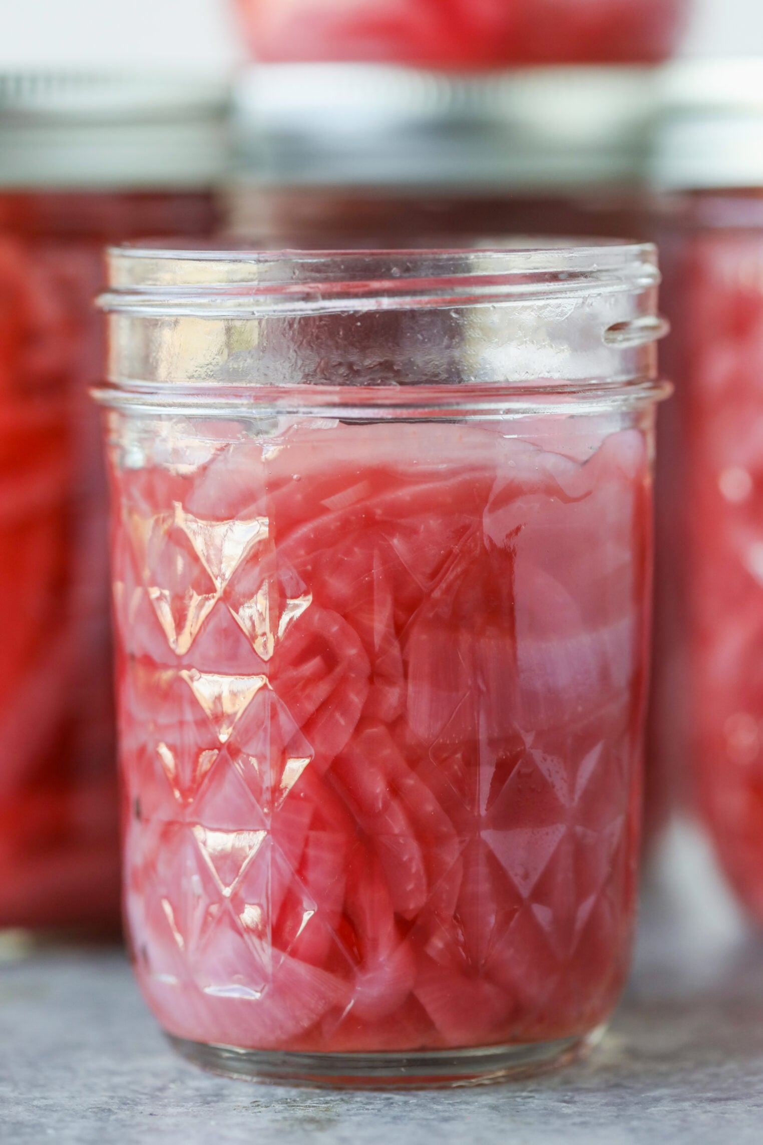 Pickled Red Onions 1 A Glass Mason Jar Filled With Bright Pink Pickled Red Onions.