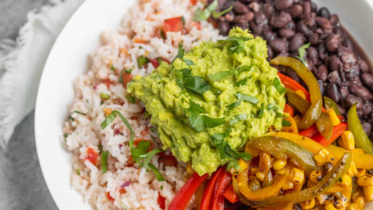 Bowl Of Rice Beans And Peppers With Avocado