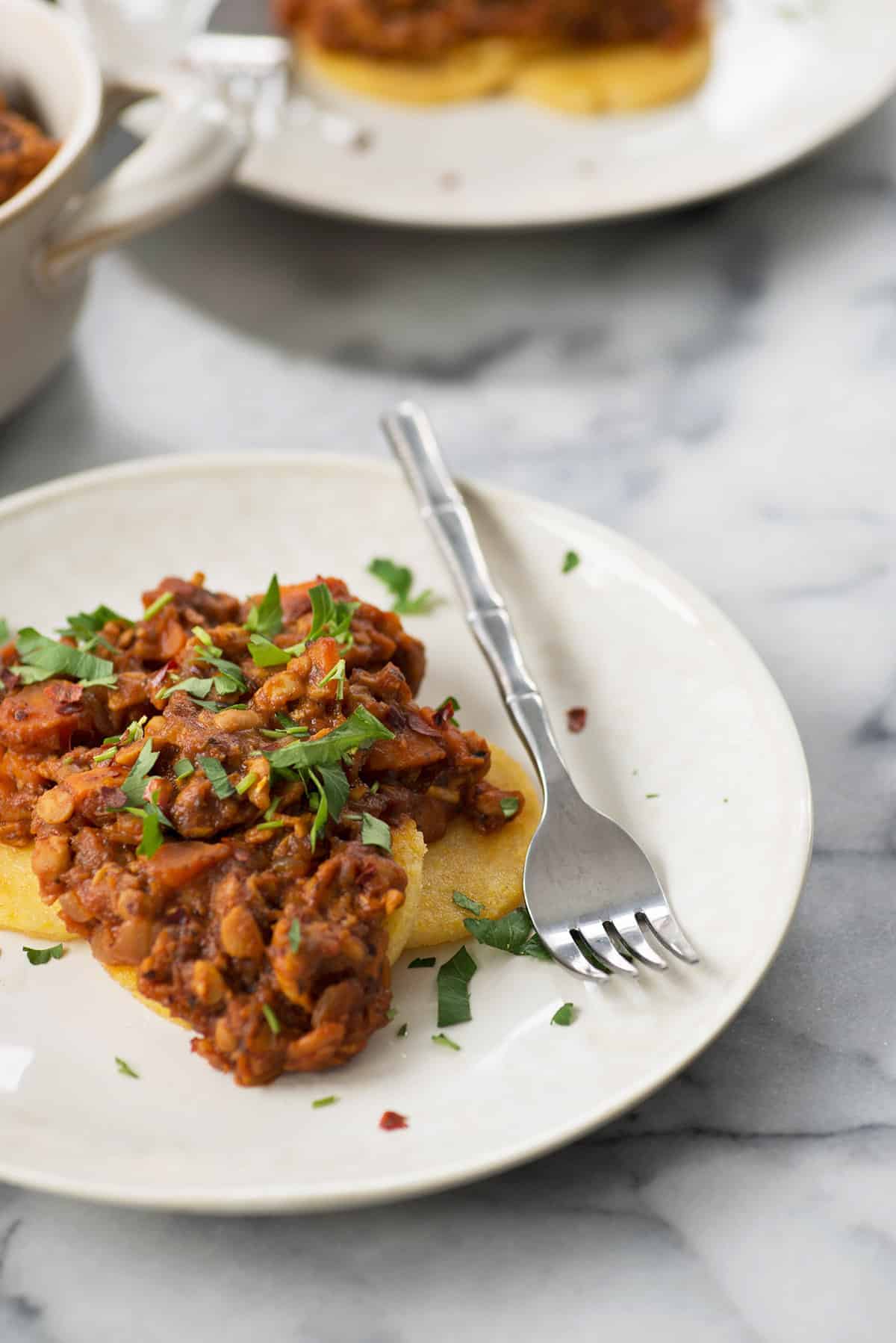 Polenta Cakes With Tempeh Bolognese! Crispy Polenta Topped With A Meaty, Vegan Ragu. Healthy Comfort Food! | Www.delishknowledge.com 