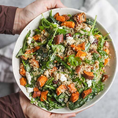 Sweet Potato and Quinoa Salad 8 Hands Holding A Bowl Of Sweet Potato And Quinoa Salad