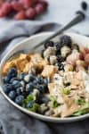 Rainbow Berry Salad with Almond Dressing. This salad is bursting with fresh fruit, crispy tofu, feta, almonds and a bright almond-butter dressing. Vegetarian and gluten-free | www.delishknowledge.com