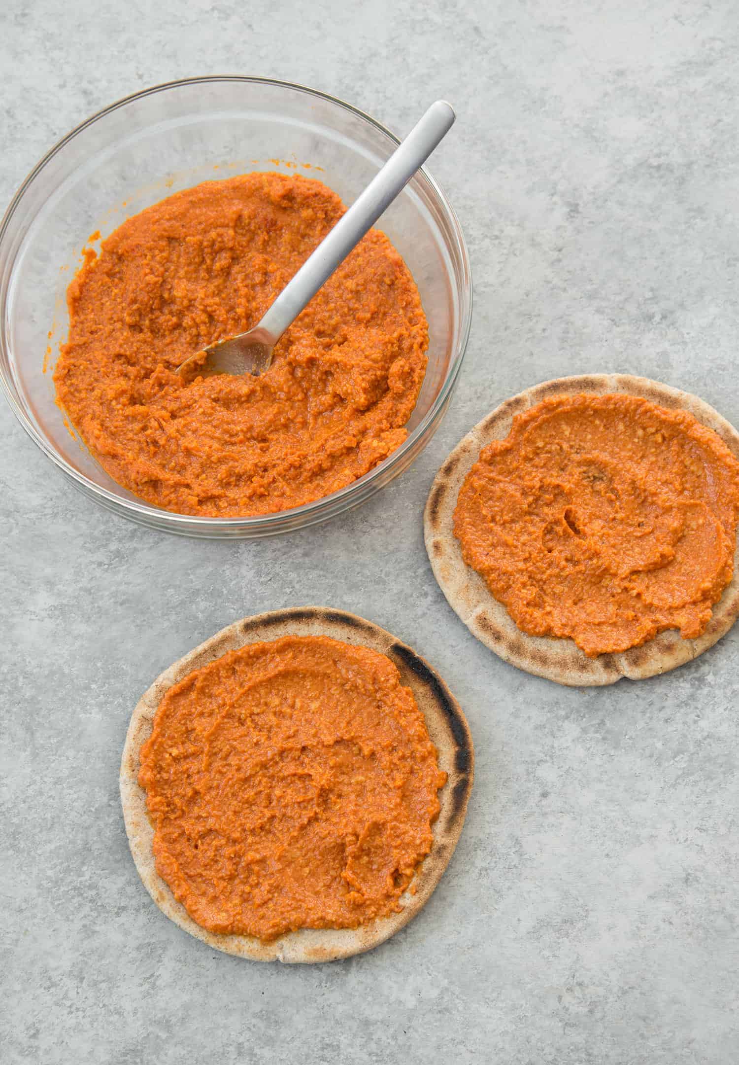 Spread The Romesco Sauce On Pita Breads 