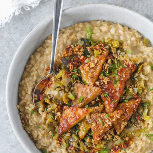 A Bowl Of Food With A Spoon.