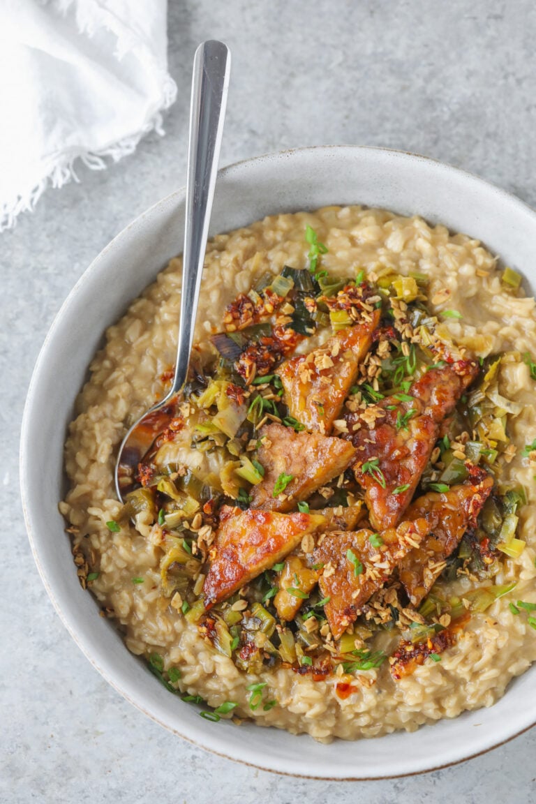 A Bowl Of Food With A Spoon.
