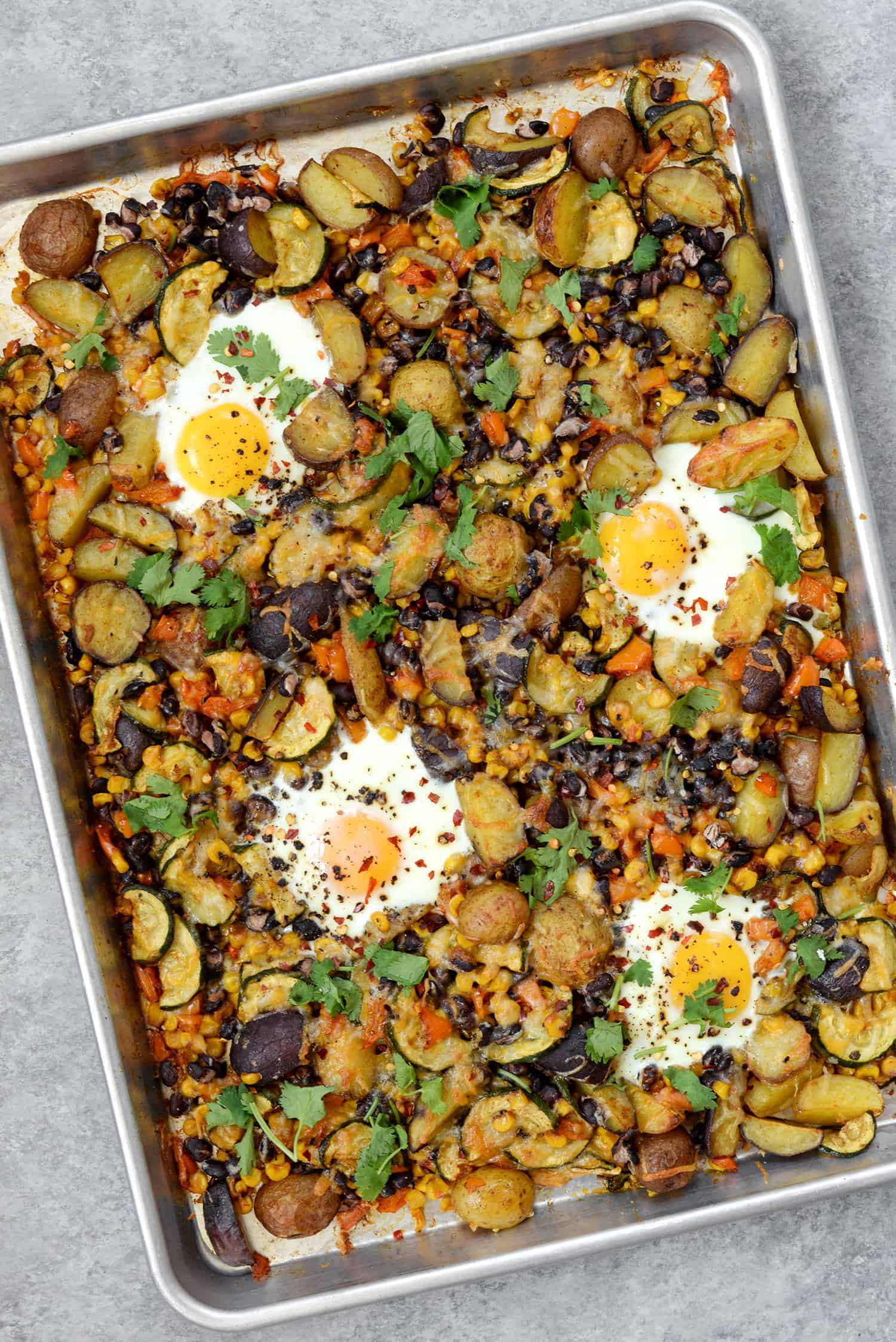 Sheet Pan Breakfast Hash! You Are Going To Love This Quick And Easy Dinner (Or Breakfast) Idea. Roasted Potatoes, Zucchini, Peppers, Beans, Corn And Eggs. High-Protein, Vegetarian And Gluten-Free. | Www.delishknowledge.com