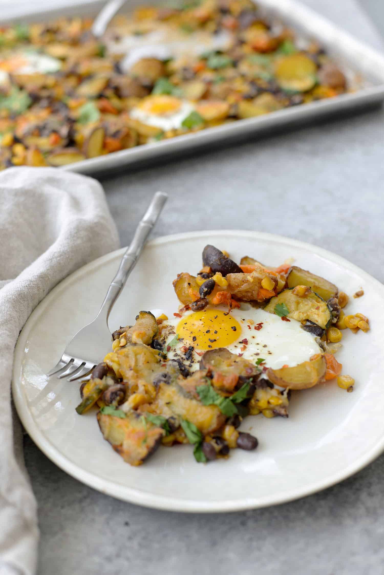 Sheet Pan Breakfast Hash! You Are Going To Love This Quick And Easy Dinner (Or Breakfast) Idea. Roasted Potatoes, Zucchini, Peppers, Beans, Corn And Eggs. High-Protein, Vegetarian And Gluten-Free. | Www.delishknowledge.com