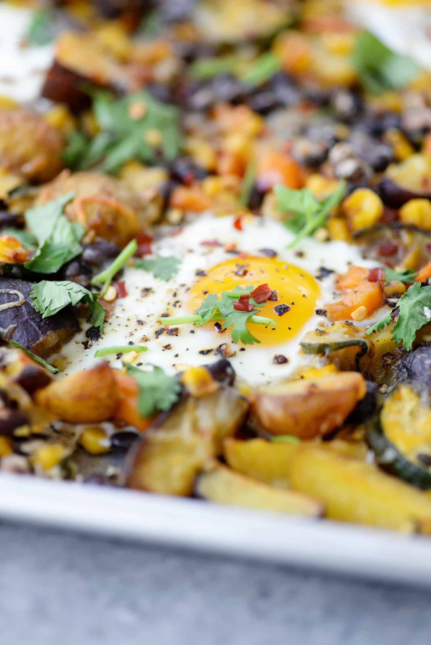 Sheet Pan Breakfast Hash! You Are Going To Love This Quick And Easy Dinner (Or Breakfast) Idea. Roasted Potatoes, Zucchini, Peppers, Beans, Corn And Eggs. High-Protein, Vegetarian And Gluten-Free. | Www.delishknowledge.com