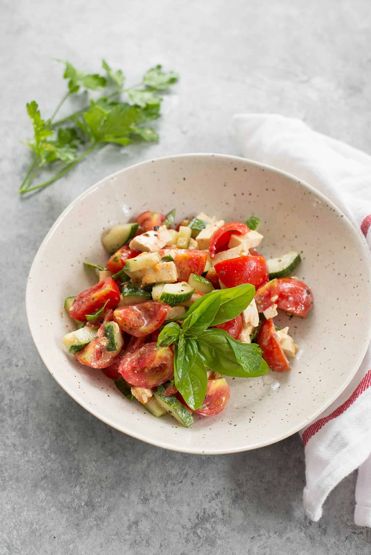 Tomato And Vegan Tofu Feta Cheese Served Garnished With Fresh Basil 