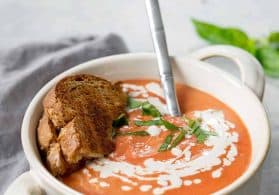 creamy vegan slow cooker tomato soup in white bowl