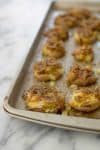 Smashed Potatoes with Shallot Dressing! Save this when you need an easy side-dish for the holidays. Ready in less than 30 minutes! Smashed, crispy potatoes topped with buttery shallot dressing. Vegan and Gluten-Free. | www.delishknowledge.com