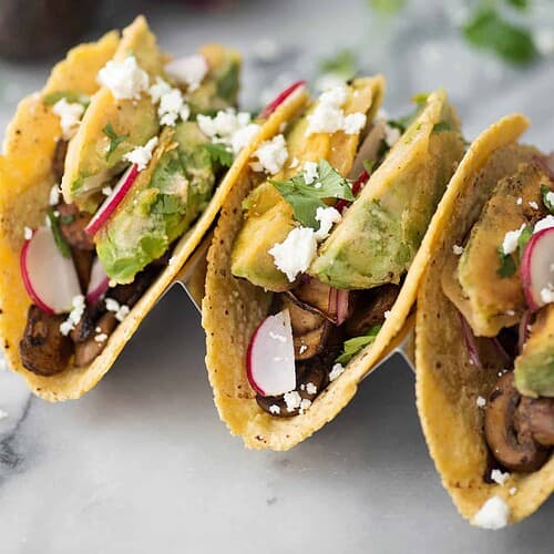 Spicy Mushroom and Crispy Avocado Tacos 5 Spicy Mushroom And Black Bean Tacos With Crispy Avocado. These Vegetarian Tacos Are Loaded With Flavor And Texture! Crispy Fried Avocado, Pickled Onions, Spicy Mushroom And Bean Filling And Goat Cheese. | Www.delishknowledge.com