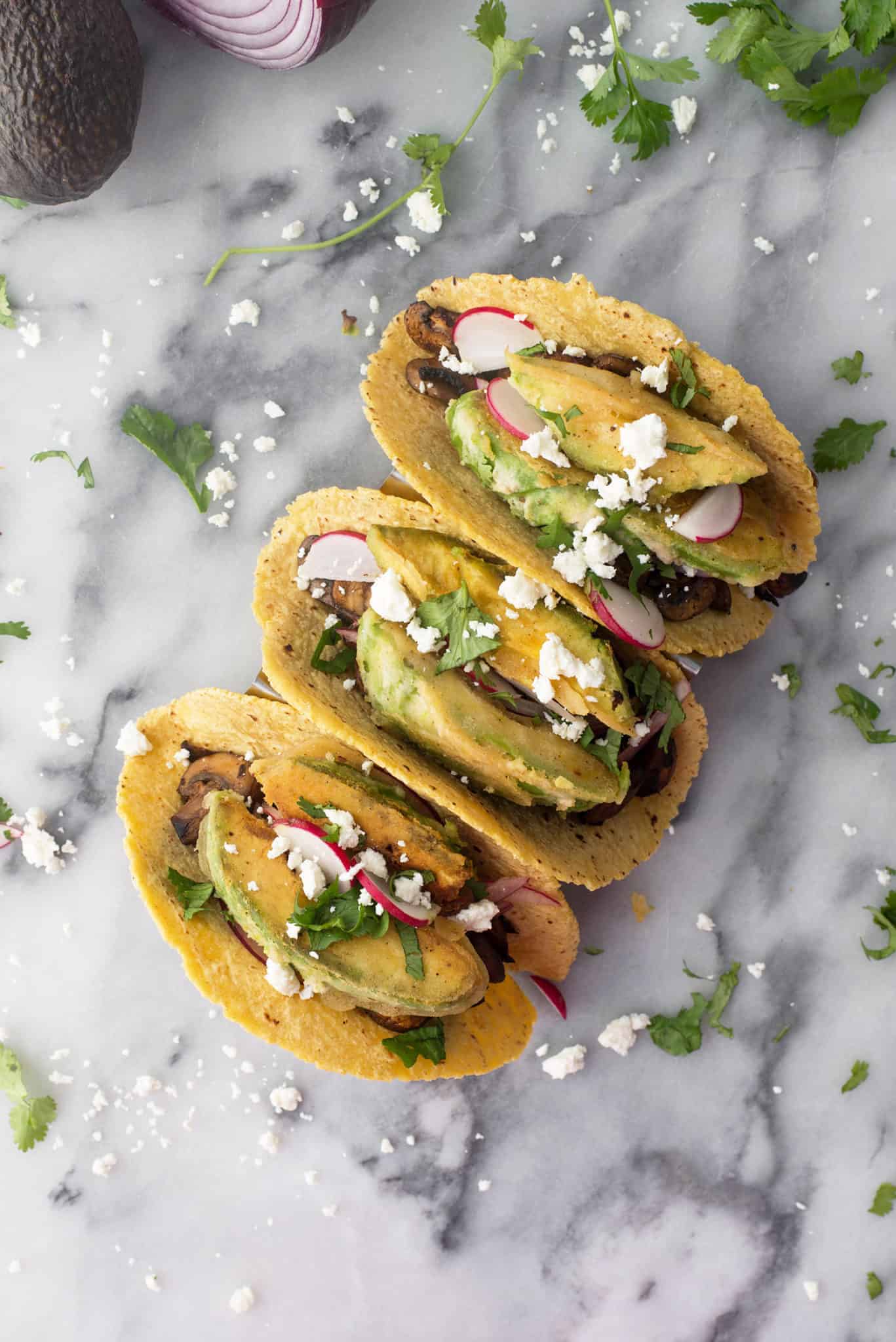 Spicy Mushroom And Black Bean Tacos With Crispy Avocado. These Vegetarian Tacos Are Loaded With Flavor And Texture! Crispy Fried Avocado, Pickled Onions, Spicy Mushroom And Bean Filling And Goat Cheese. | Www.delishknowledge.com