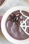 smoothie bowl with yogurt spider web and raisin spider