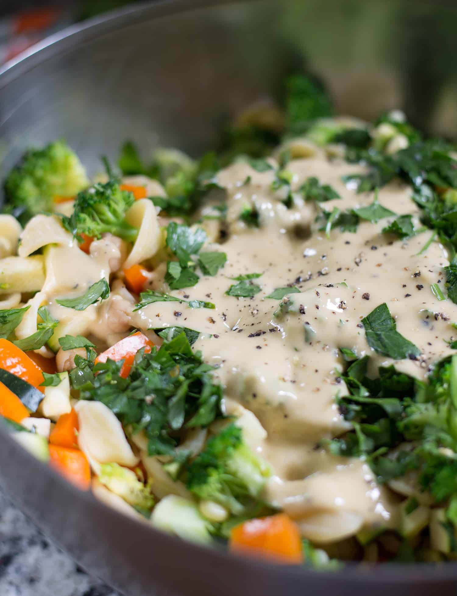 Tossing The Salad With The Lemon-Tahini Dressing 