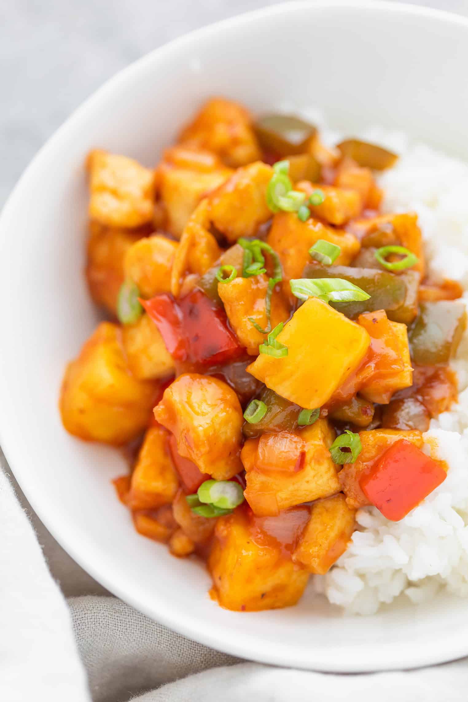 sweet and sour tofu with rice in a bowl