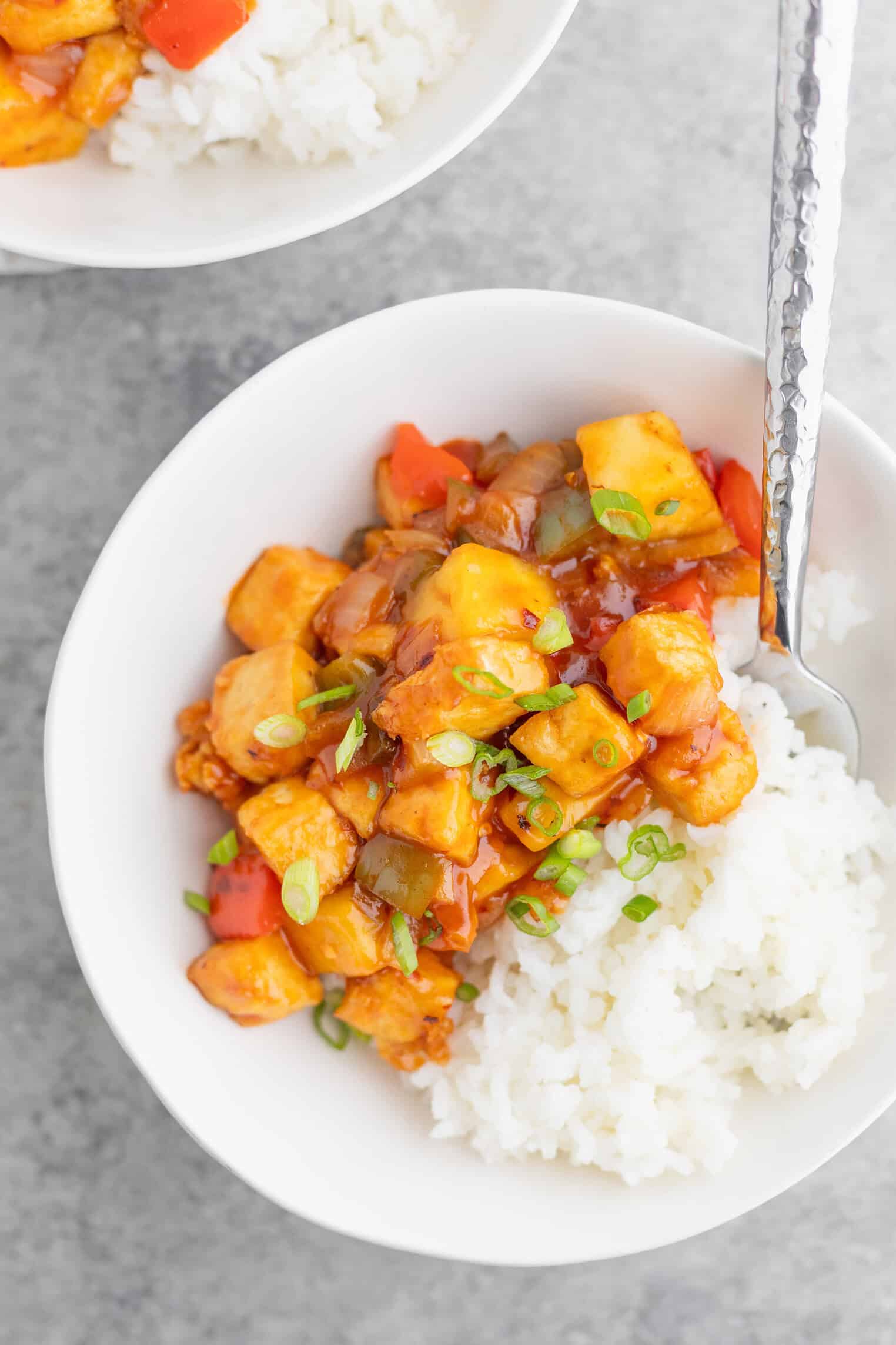 sweet and sour tofu with rice in a bowl