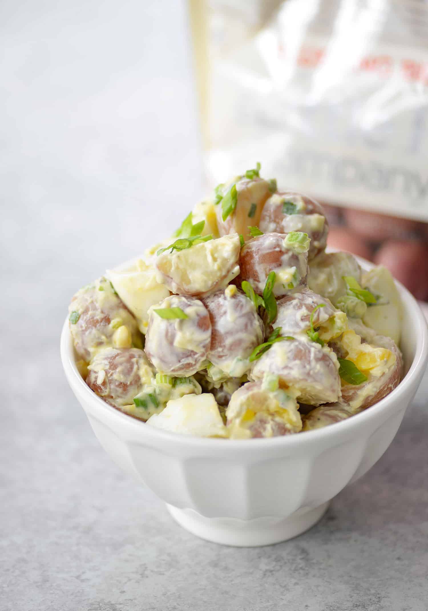 Tarpon Springs Greek Salad With Potato Salad. You'Ve Never Had Greek Salad Like This Before! A Layer Of Potato Salad Topped With Tangy Greek Salad And Homemade Dressing. A Healthy And Delicious Lunch Or Dinner Option. Lightened Up Potato Salad Made With Greek Yogurt. | Www.delishknowledge.com #Glutenfree #Vegetarian #Lunch #Healthy #Salad #Greeksalad #Lowfat #Eatinghealthy #Potatosalad