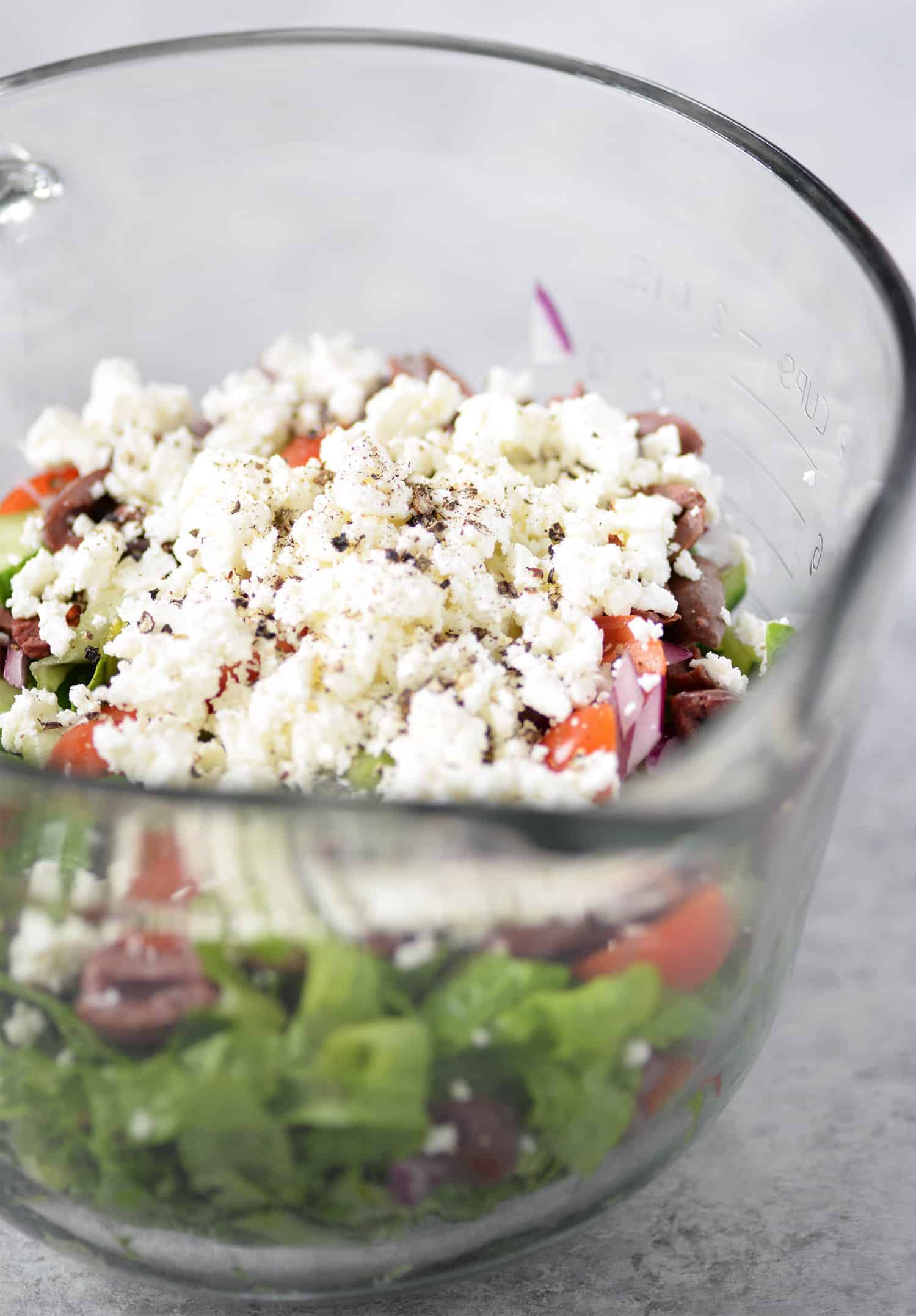 Tarpon Springs Greek Salad With Potato Salad. You'Ve Never Had Greek Salad Like This Before! A Layer Of Potato Salad Topped With Tangy Greek Salad And Homemade Dressing. A Healthy And Delicious Lunch Or Dinner Option. Lightened Up Potato Salad Made With Greek Yogurt. | Www.delishknowledge.com #Glutenfree #Vegetarian #Lunch #Healthy #Salad #Greeksalad #Lowfat #Eatinghealthy #Potatosalad