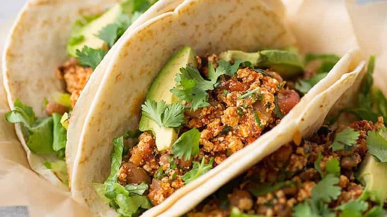Three Sofrito Tacos On Wax Paper