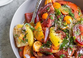 heirloom tomatoes with herbs in a bowl