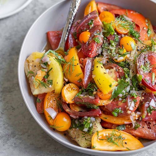 Heirloom Tomatoes With Herbs In A Bowl