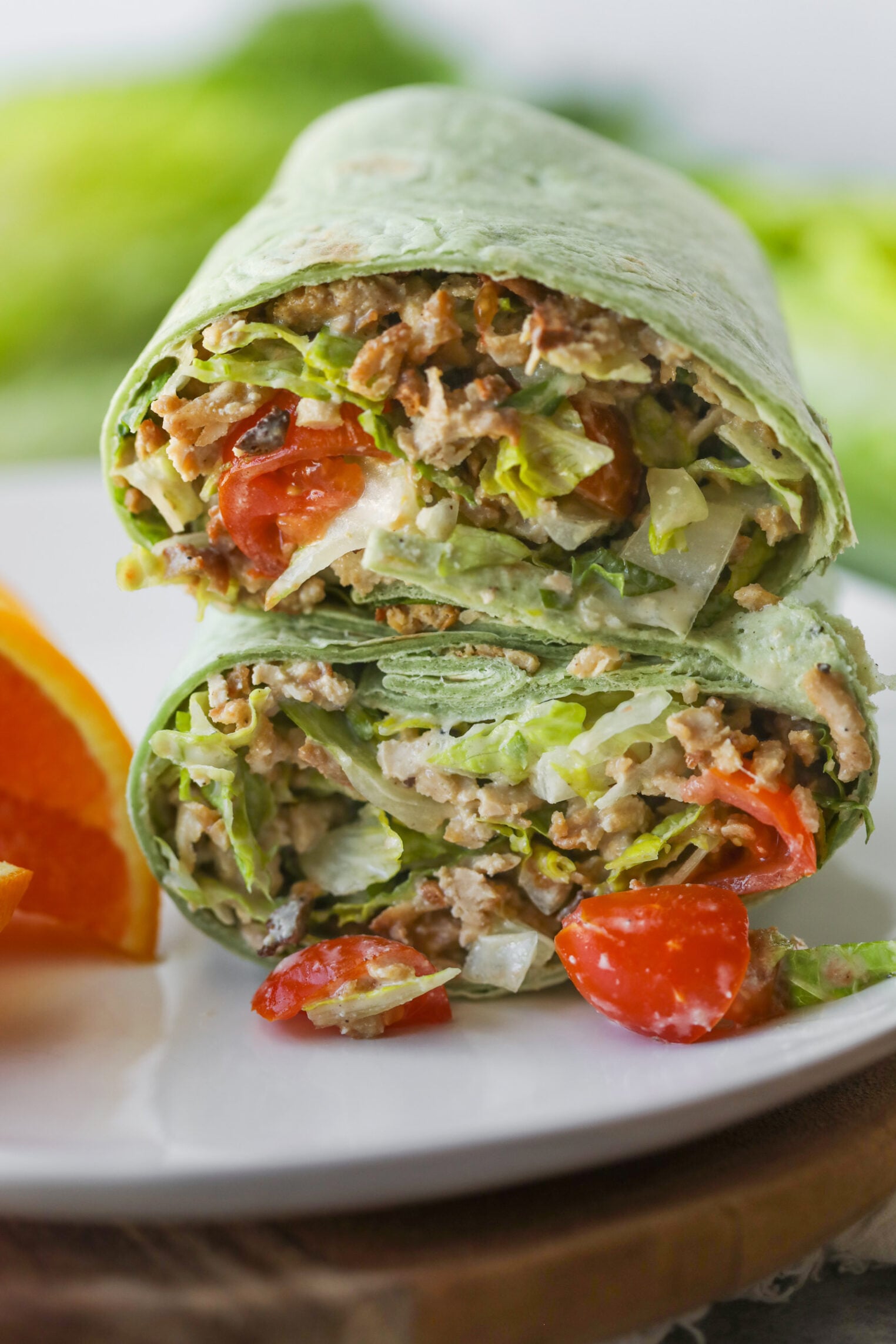 Vegan Chicken Caesar Wrap Cut In Half On A White Plate
