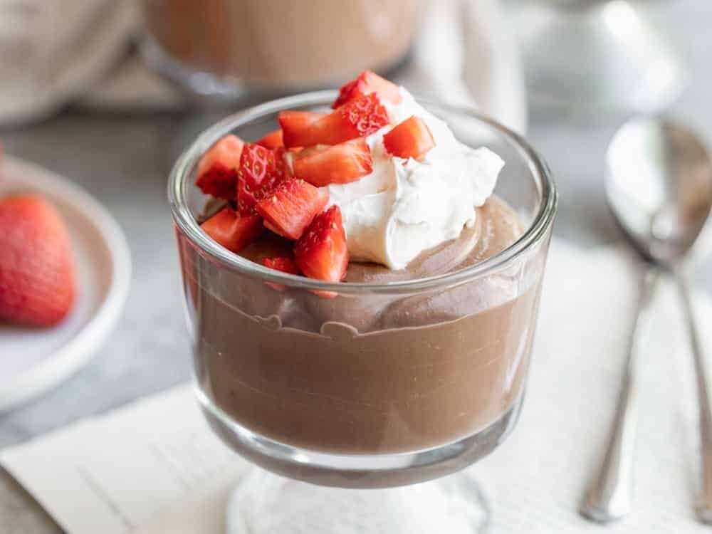 close up of vegan pudding in a glass with berries