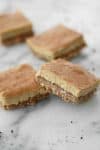 Vegan Espresso Cheesecake Bars! You will LOVE these creamy, dairy-free cheesecake bars. An almond and walnut crust topped with a creamy espresso vanilla cheesecake filling. A must-make for the holidays! | www.delishknowledge.com