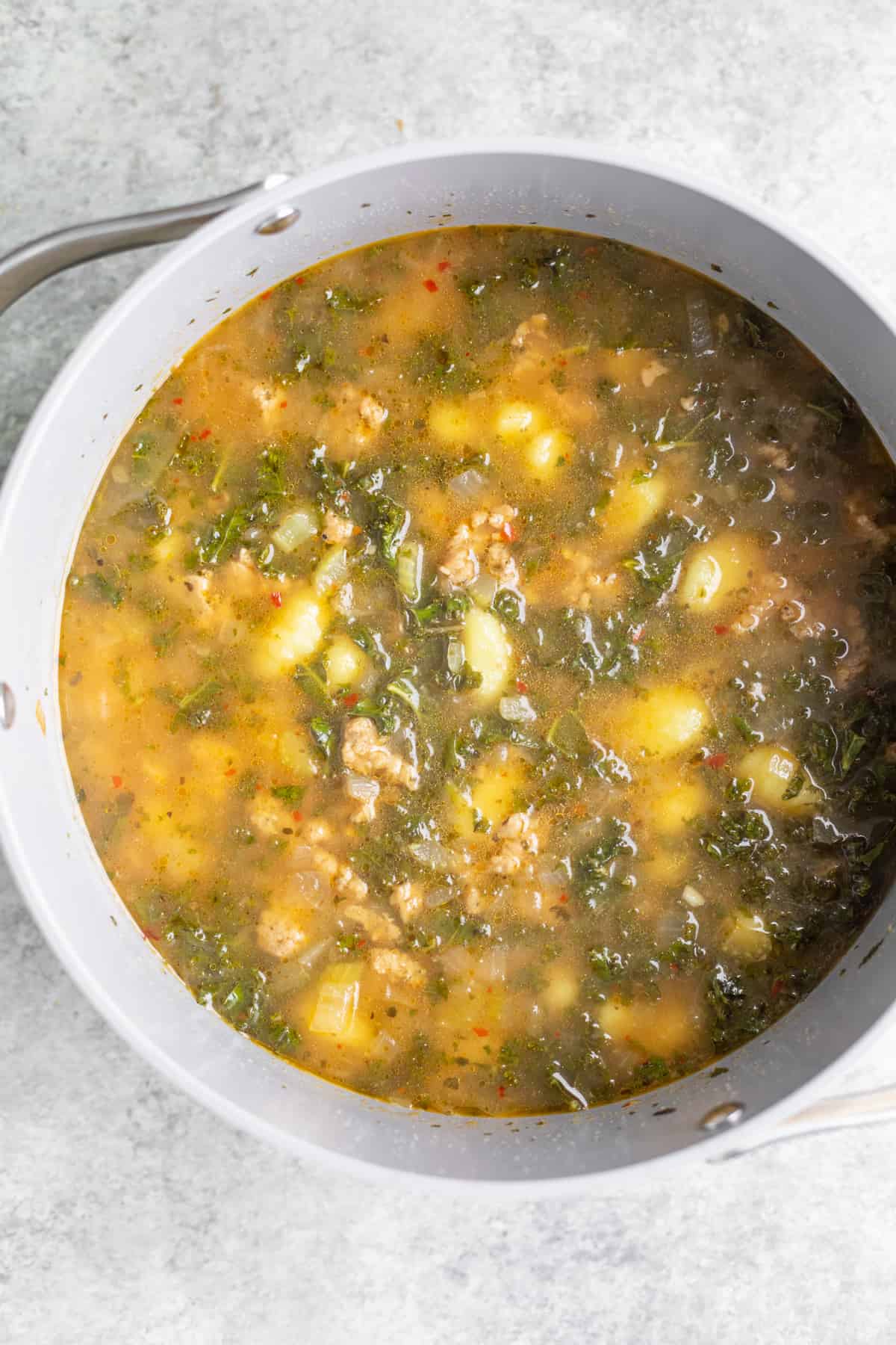 Gnocchi And Vegan Sausage In A Soup Pan With Vegetable Broth