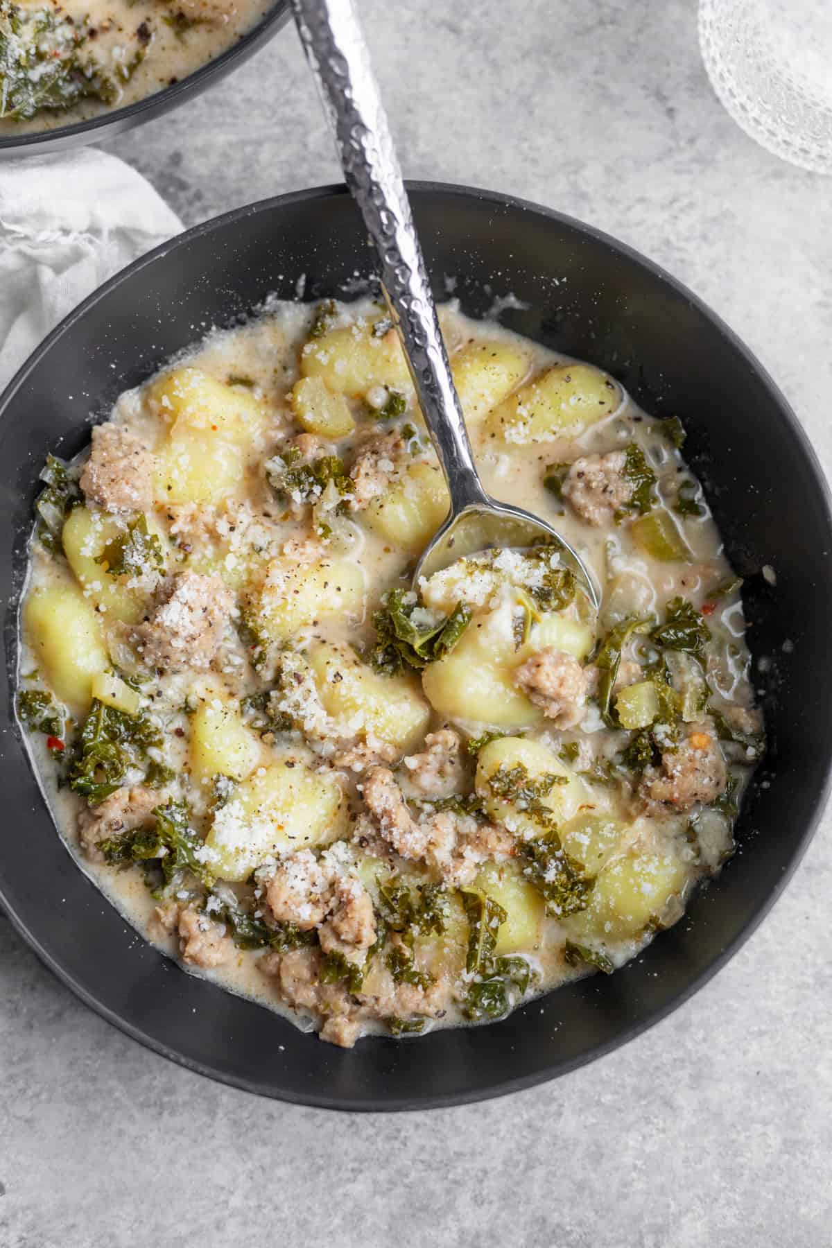 Creamy Gnocchi Soup In A Bowl With A Spoon