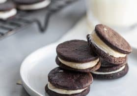 vegan oreo cookies stacked on a plate