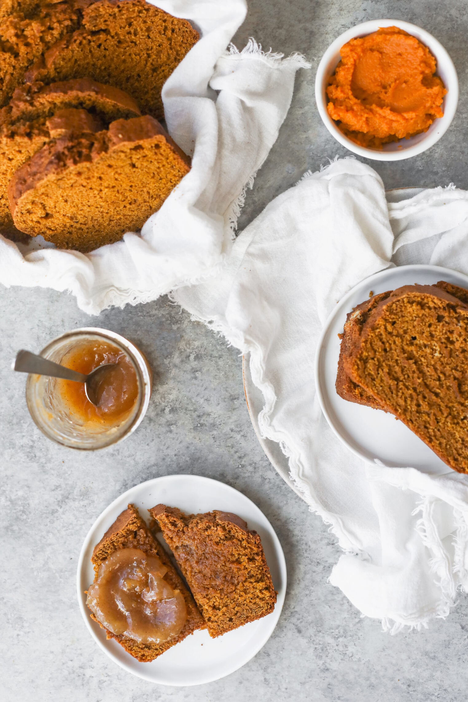 Slices Of Vegan Pumpkin Bread Served With A Side Of Pumpkin Purée And A Jar Of Apple Butter.