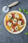 Vegan Pizza! Fresh margherita pizza with cashew mozzerella cheese, heirloom tomatoes and fresh basil. | www.delishknowledge.com