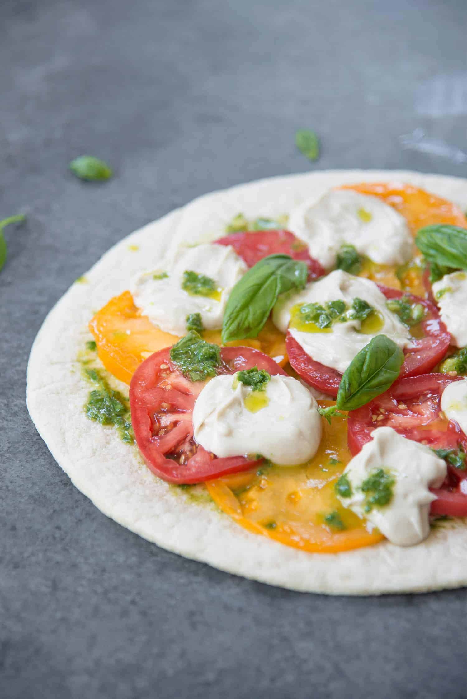 Vegan Pizza! Fresh Margherita Pizza With Cashew Mozzerella Cheese, Heirloom Tomatoes And Fresh Basil. | Www.delishknowledge.com