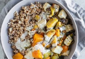 Weeknight dinner, coming up! This Winter Buddha Bowl is packed with seasonal favorites: roasted butternut squash, brussels sprouts, tofu, carrots, farro and a maple mustard tahini dressing.