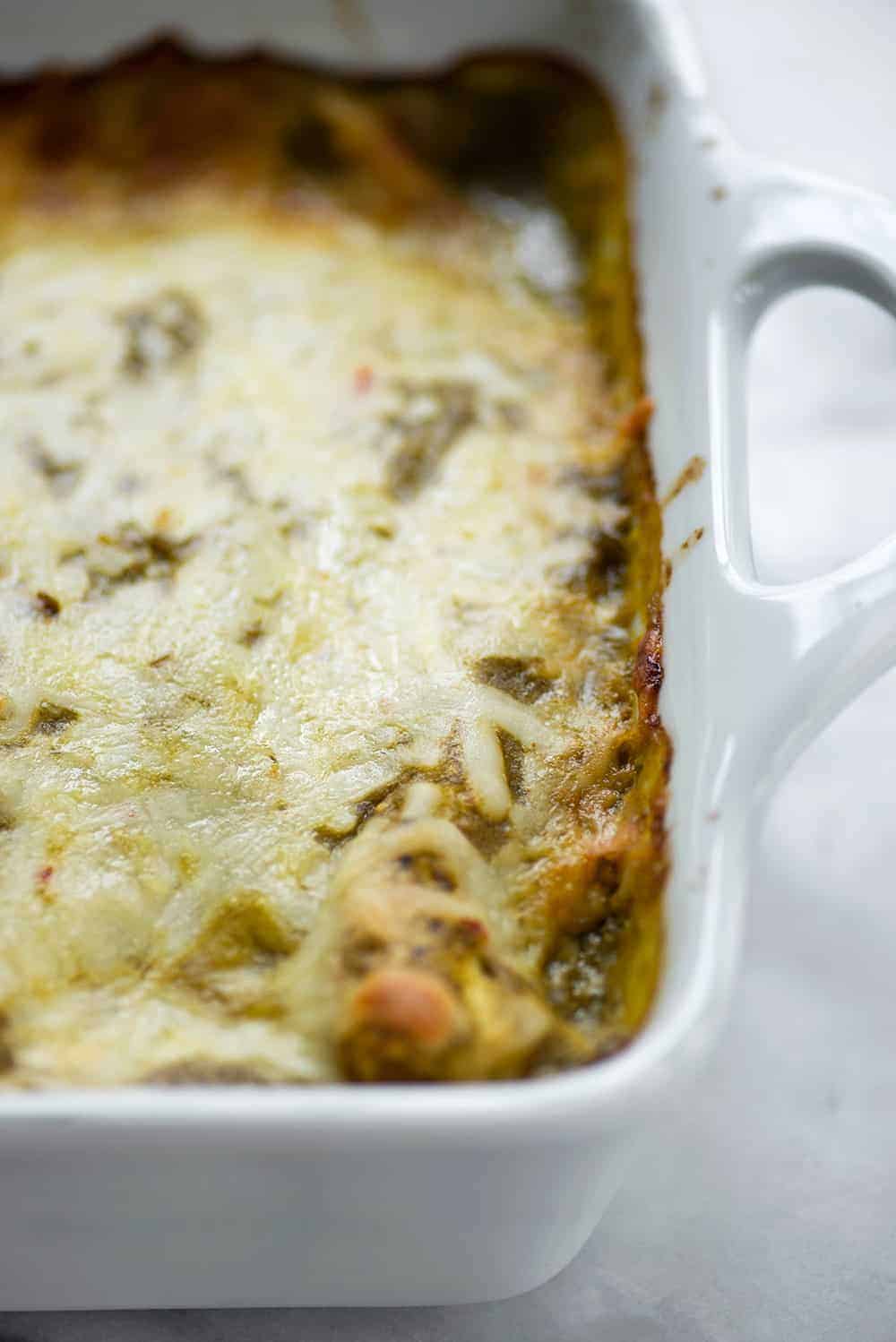 close up shot of vegetarian enchiladas verdes with pepperjack cheese